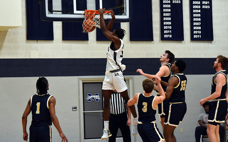 Sophomore forward Marquis Ratcliff throws down a dunk during the first half versus Juniata College in Johnston Hall.