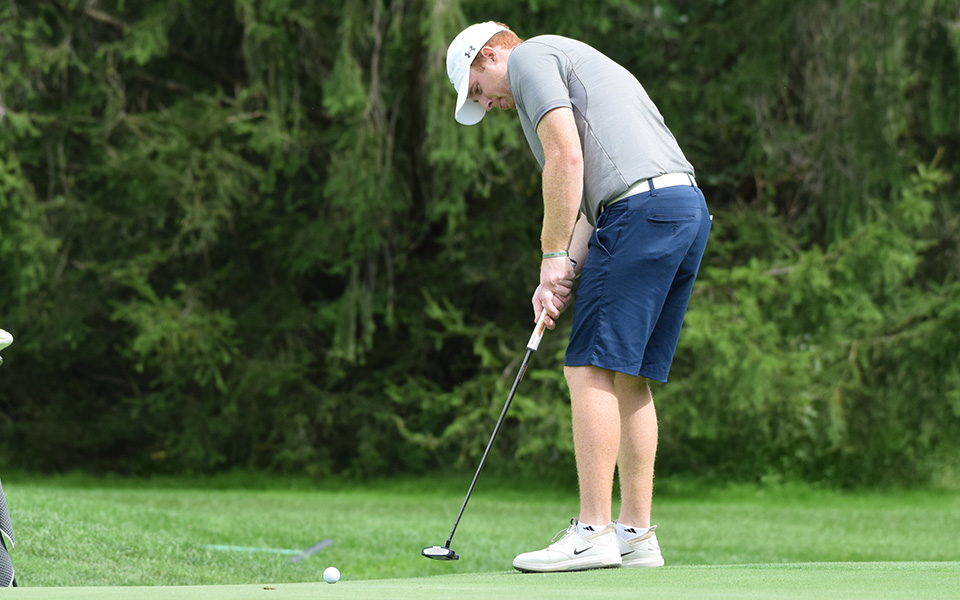 Senior Nick Kuhn sinks a putt on the fifth hole during the Moravian Weyhill Classic at the Saucon Valley Country Club.