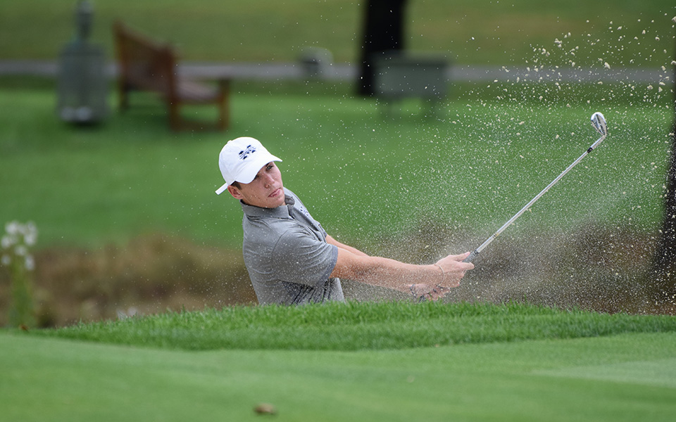 Sophomore Will Breslin watches a shot out of a bunker nearly hole out on the fifth green during the Moravian Weyhill Classic at Saucon Valley Country Club.