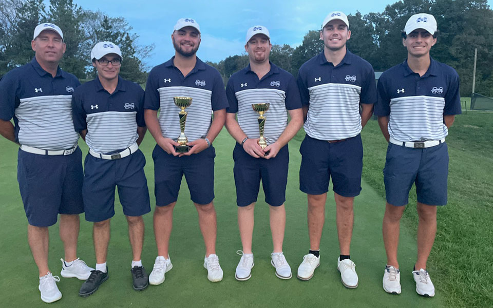 The Greyhounds pose with the championship trophy from the Ursinus College Invitational, and graduate student Nick Kuhn '20 holds the medalist trophy for taking first with an even par round of 71.