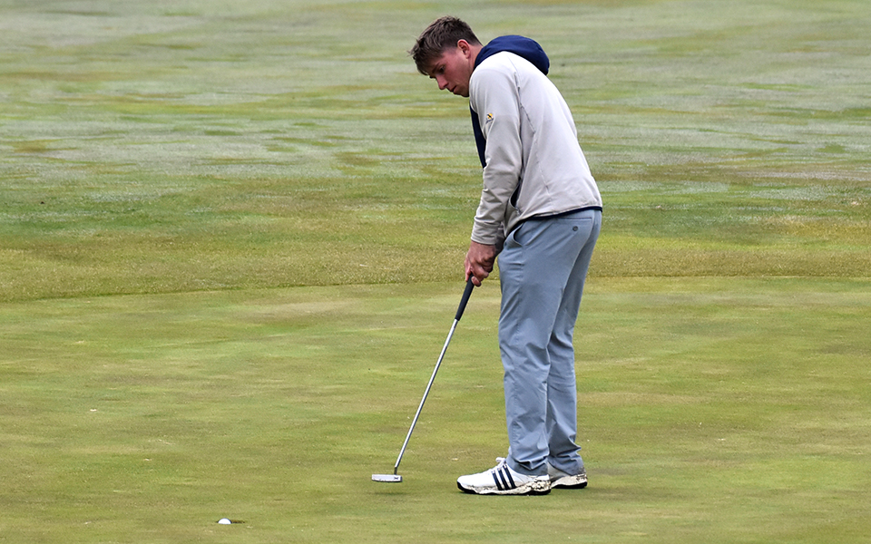 Freshman Jake Haberstumpf sinks a putt on the ninth green at Olde Homestead Golf Course during the Moravian Spring Classic.