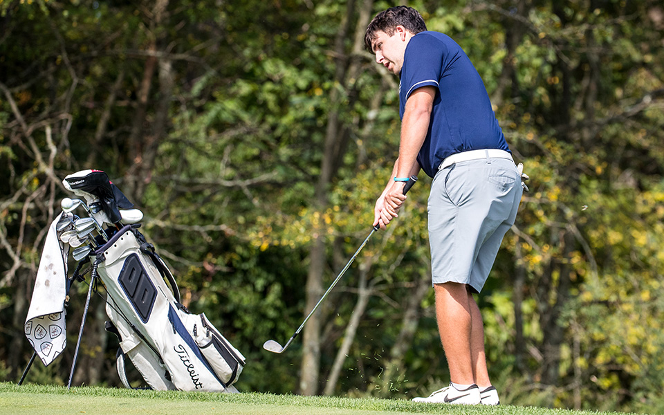 Senior Jason Koch chips during the Moravian Weyhill Classic at the Saucon Valley Country Club Weyhill Course this season. Photo by Cosmic Fox Media / Matthew Levine '11