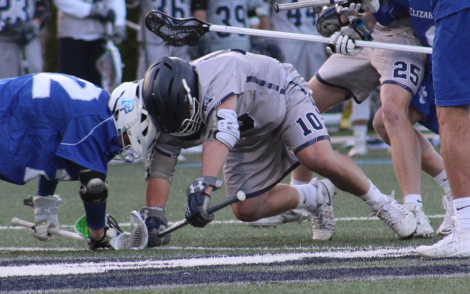Senior Rick Guerra takes a face-off versus Elizabethtown College on John Makuvek Field. Guerra set school marks for career face-offs taken and won during the match at Cabrini University.