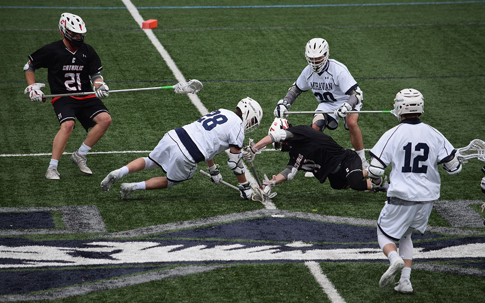 Max Towers '21 on a face-off in a match versus The Catholic University of America on John Makuvek Field on April 21, 2021.
