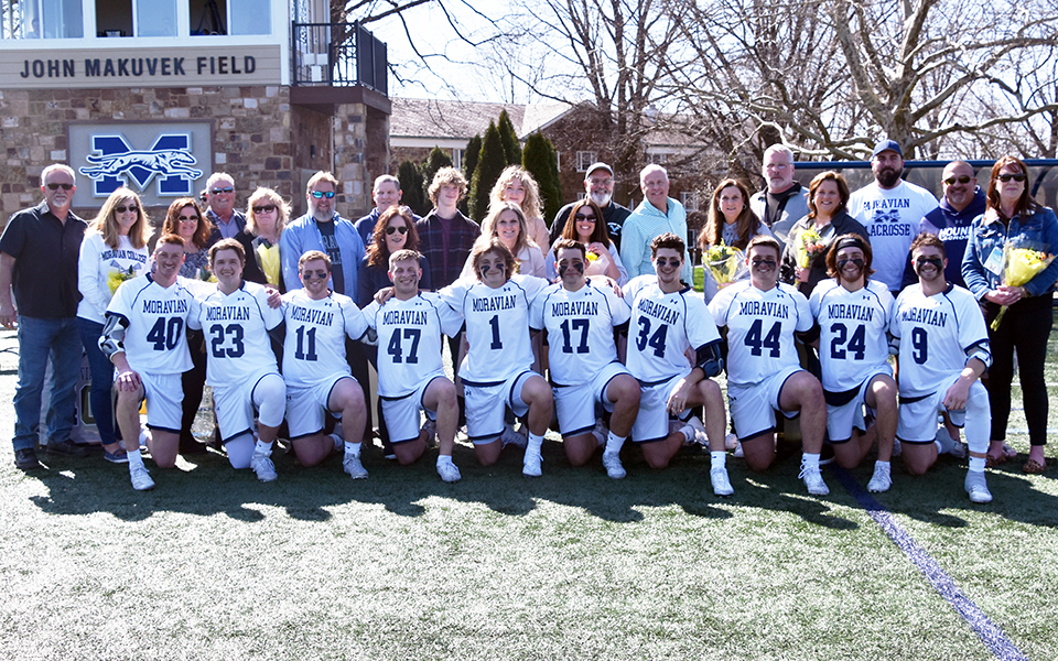 The Moravian University 2022 seniors and their parents before the Greyhounds rallied for a win over Susquehanna University on John Makuvek Field. Photo by Marissa Werner '23