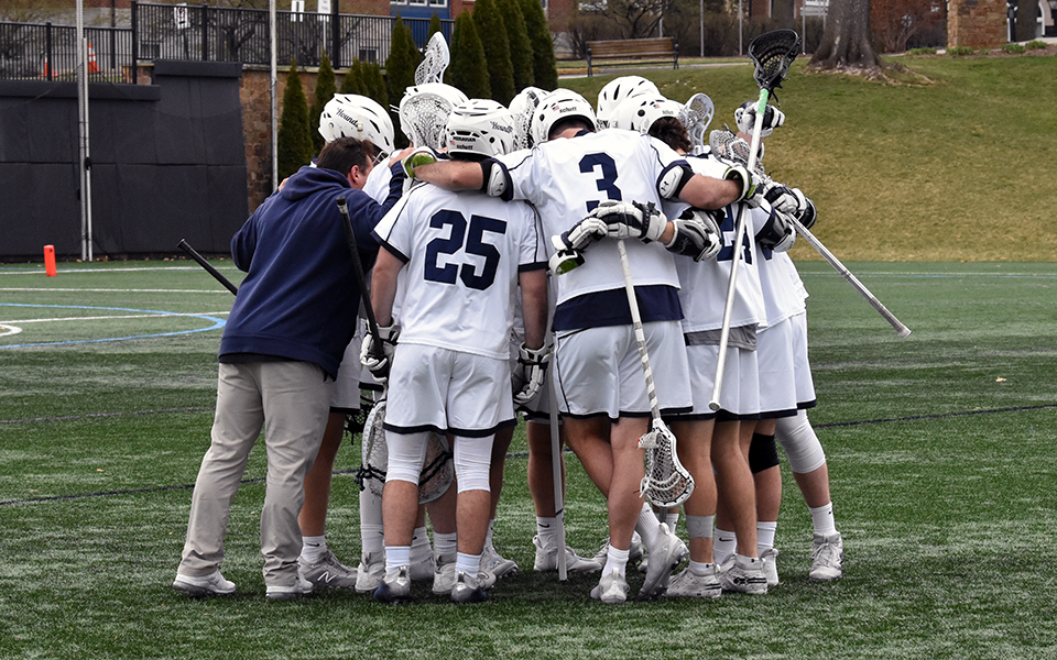 The Greyhounds huddle before the start of a match versus Drew University in March 2022 on John Makuvek Field. Photo by Marissa Werner '23