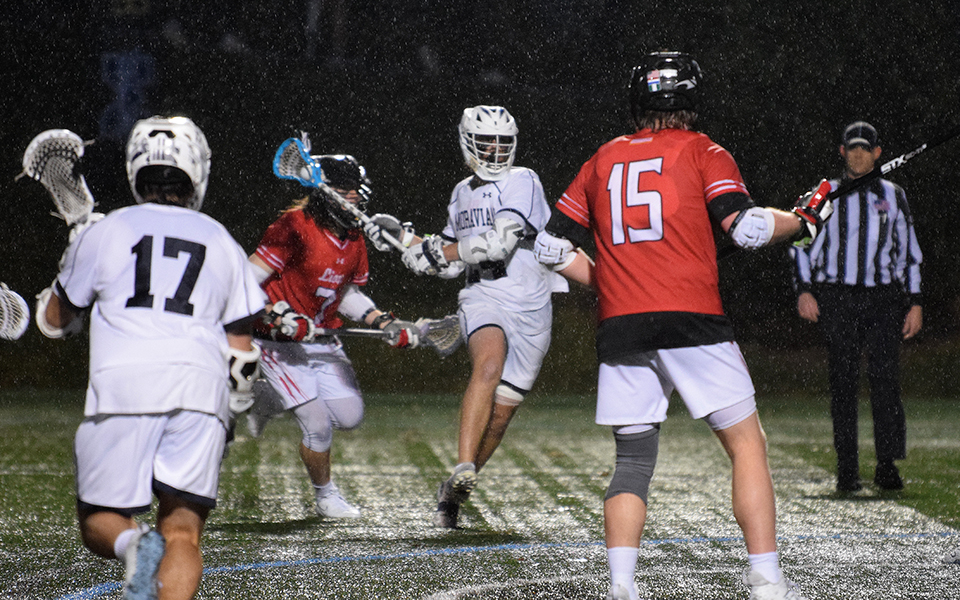 Graduate student attack Connor James gets set to take a shot during the third quarter versus Albright College on a rainy John Makuvek Field. Photo by Marissa Williams '26