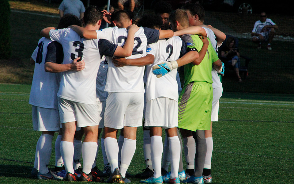 The Greyhounds huddle before the second half in a non-conference match versus Lycoming College on John Makuvek Field.