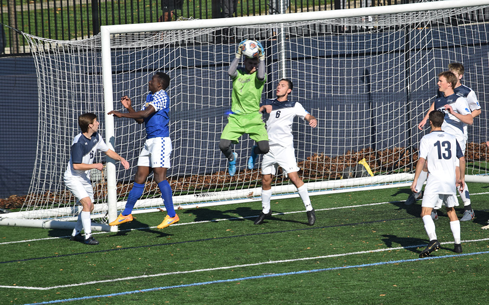 Junior Michael Bone jumps for the ball on a corner kick by Goucher College in the first half on John Makuvek Field.