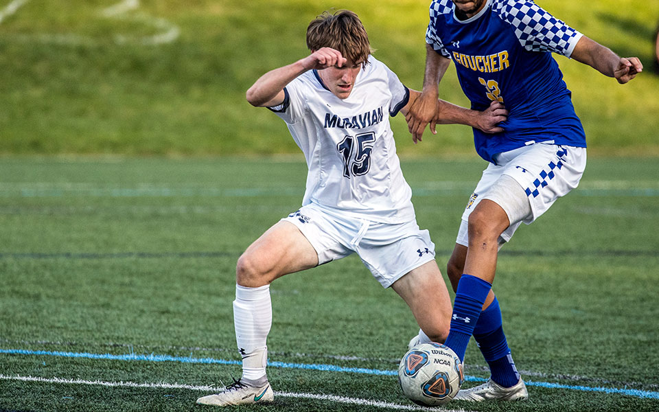 Zach Nicholas '24 wards off a defender in a game played on John Makuvek Field earlier this season.