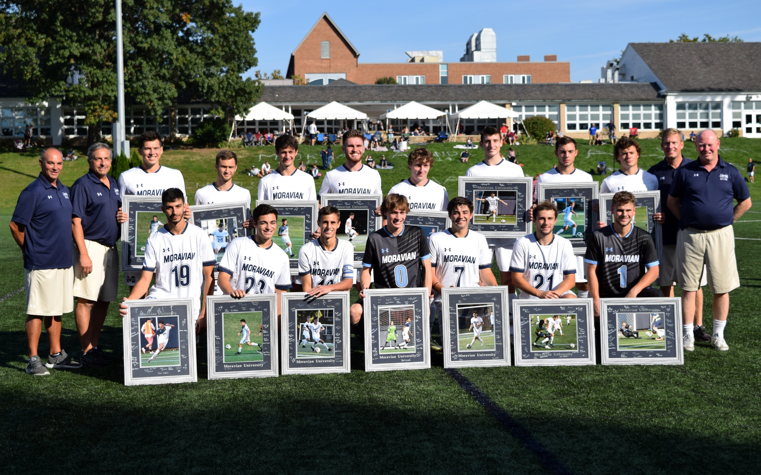 The 15 seniors in the Class of 2022 with the men's soccer coaching staff prior to the Senior Day match with Goucher College on John Makuvek Field. Photo by Mairi West '23.