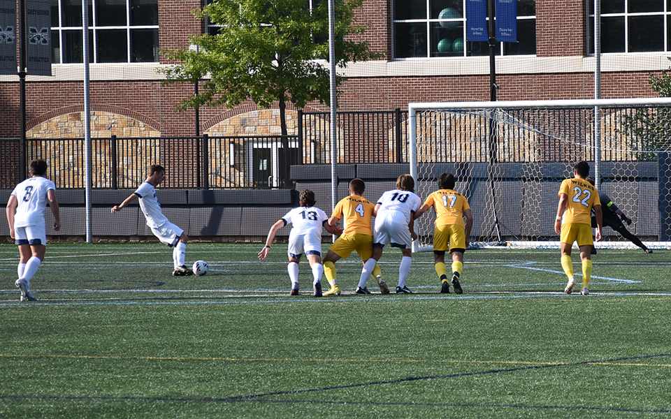Junior defender Donald Gibbs takes a penalty kick with four seconds left in the first half to give Moravian a 1-0 lead on John Makuvek Field. Photo by Alex Dillon '26