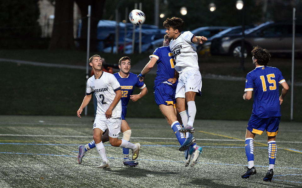Junior forward Ben Scary heads a ball during the first half of a non-conference match versus Widener University on John Makuvek Field.