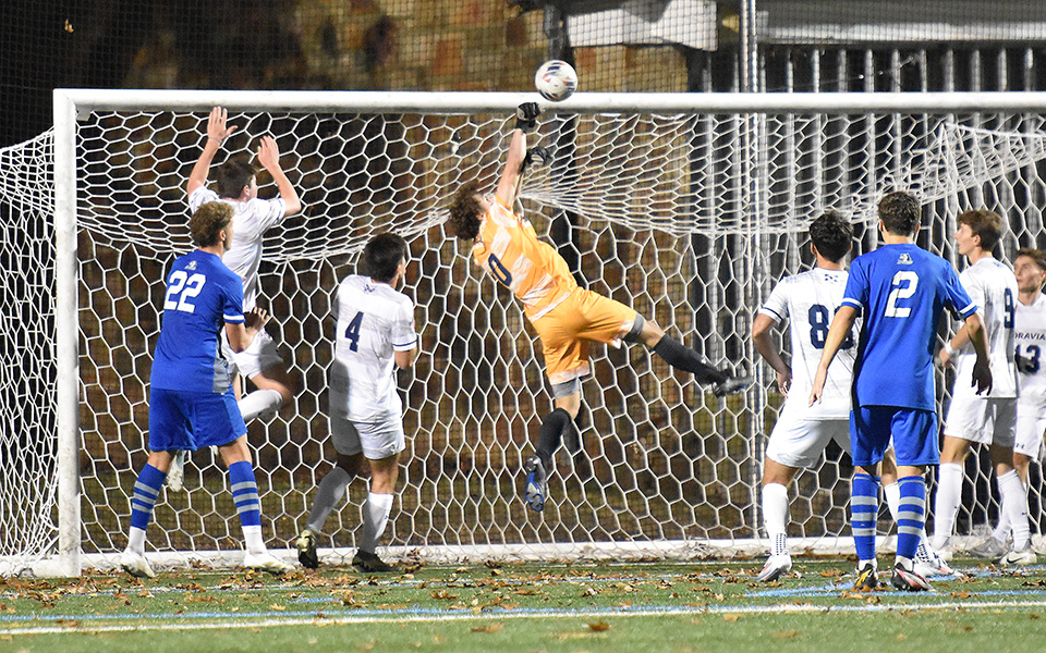 Junior goalie Casey Prajzner punches a shot over the crossbar versus Elizabethtown College on John Makuvek Field. Photo by Grace Nelson '26