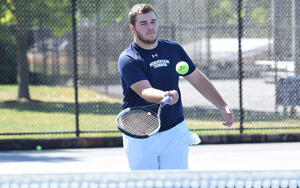 Kieran Pisani hits a volley at the net versus Misericordia University at Hoffman Courts.