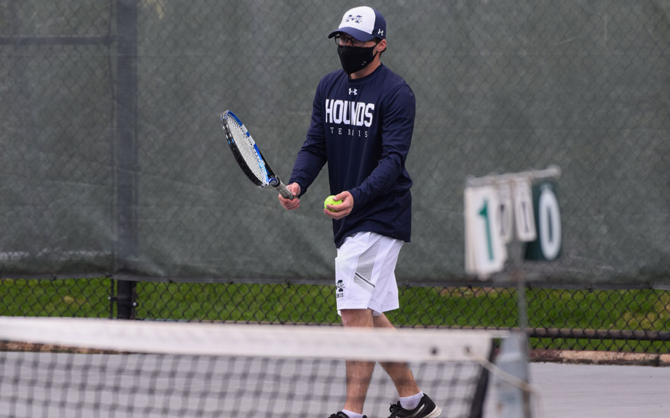 Andrew Hozza '23 gets ready to serve in a match versus Juniata College at Hoffman Courts on April17.
