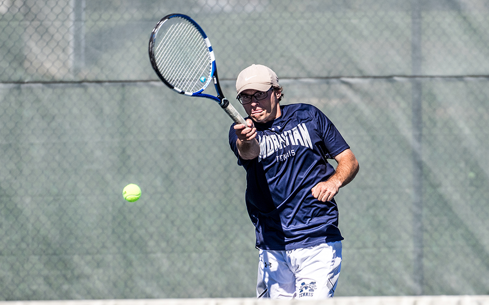 Junior Andrew Hozza returns a shot on Hoffman Tennis Courts.