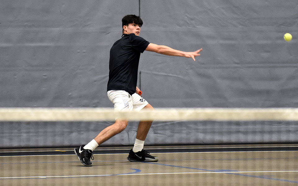 Freshman Anthony Ronca returns a shot during singles action versus Kutztown University of Pennsylvania in Timothy Breidegam Fieldhouse.