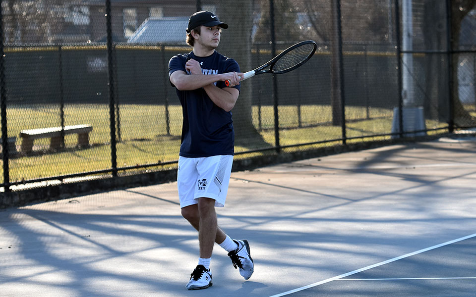 Freshman Wyatt Marshall follows through on a shot in his singles match versus Muhlenberg College at Hoffman Courts. Photo by Mairi West '23
