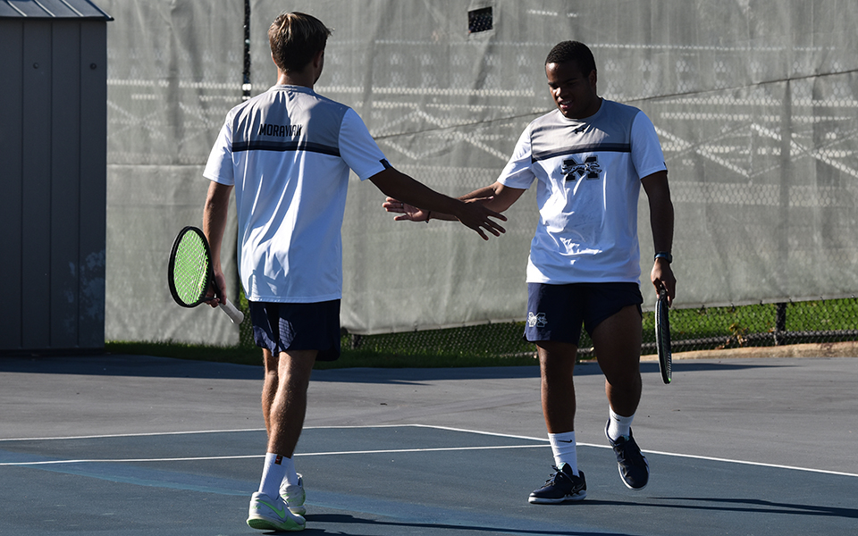Sophomores Wyatt Marshall and Ronny Pimental Ferrer celebrate a point in a doubles match versus FDU-Florham on Hoffman Courts last fall.