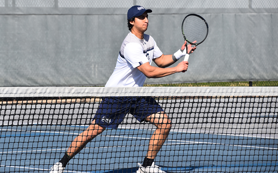 Sophomore Shayaan Farhad gets set to return a shot in doubles action versus the University of Saint Joseph (Conn.) on Hoffman Courts. Photo by Christine Fox