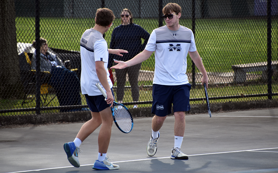 Sophomore Matthew Labosky and junior Zachary Lebby celebrate a point during their doubles contest versus Immaculata University at Hoffman Courts. Photo by Christine Fox