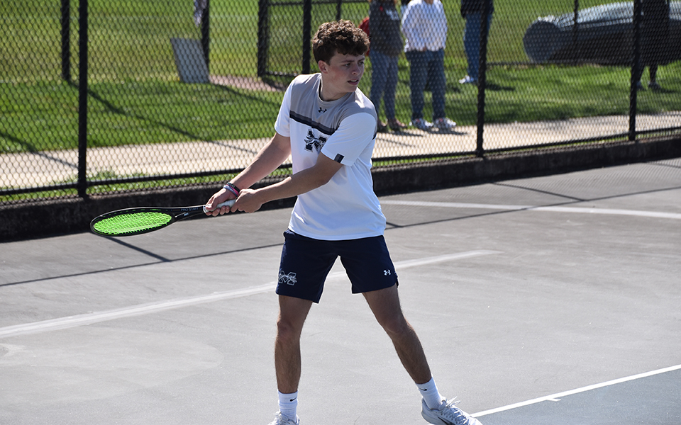 Sophomore Ryan Burke returns a shot in singles action versus The University of Scranton at Hoffman Courts. Photo by Christine Fox
