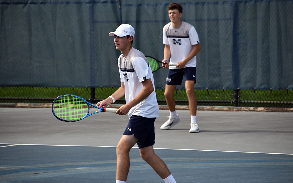 Freshman Gavin Labbadia (front) and sophomore Ryan Burke await a serve in doubles action versus Wilkes University in a 2024 Landmark Conference Tournament match at Hoffman Courts. Photo by Christine Fox