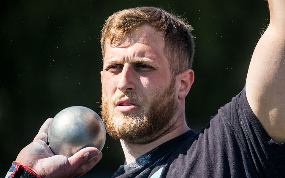 Graduate student Shane Mastro gets ready for the shot put in the Greyhound Invitational at Timothy Breidegam Track in April 2022. Photo by Cosmic Fox Media / Matthew Levine '11