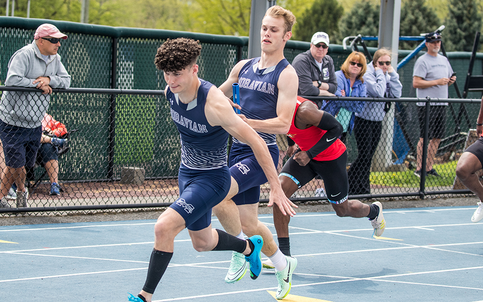 Sophomore Owen Sabastro takes the baton from Trevor Gray in the 4x100-meter relay during the Coach Pollard Invitational earlier this season. Photo by Cosmic Fox Media / Matthew Levine '11