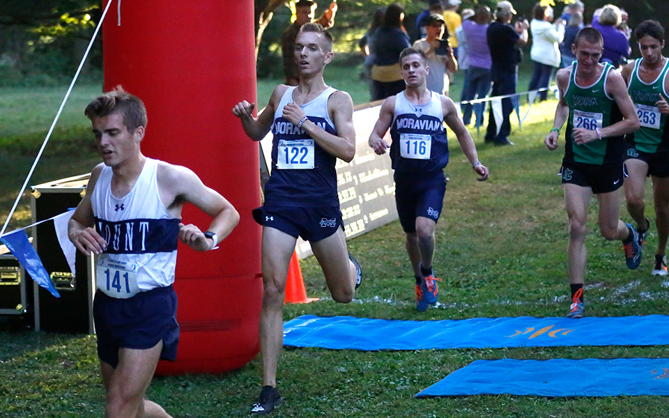 Peter Gingrich and Brad Clemson cross the finish line at the Elizabethtown College Short Course Invitational at Union Canal Tunnel Park. Photo by Wyatt Eaton.