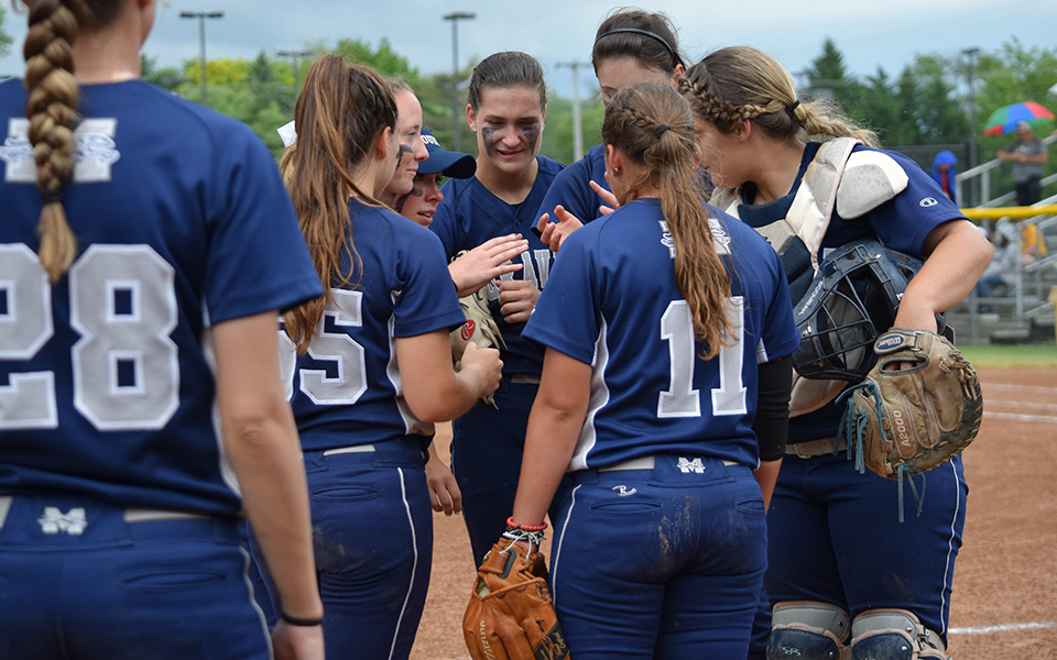 The Greyhounds talk between innings during the 2018 NCAA Division III Super Regional at Rowan University.