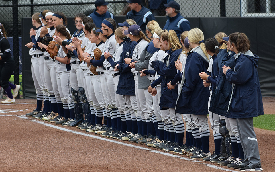 The Greyhounds await the starting lineups before the opening game of the 2019 Landmark Conference Tournament at Blue & Grey Field.