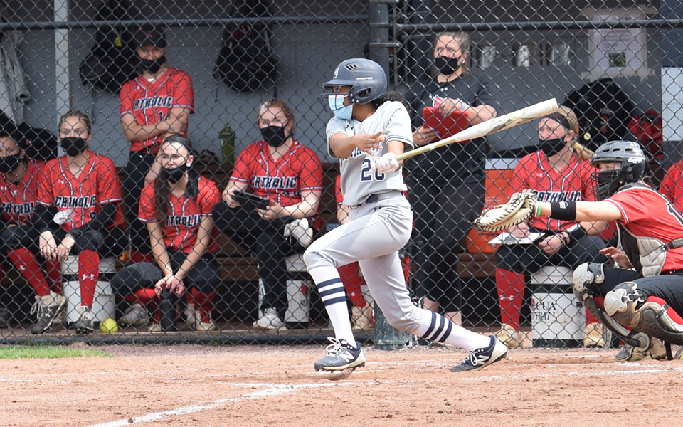 Ajala Elmore '24 connects on a two-RBI single in her first career at-bat versus The Catholic University of America at Blue & Grey Field.