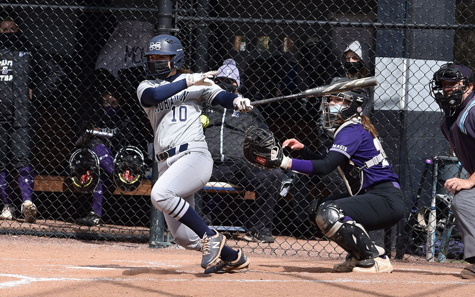 Alexis Agrapides '23 connects on a pitch during the first game of a doubleheader with The University of Scranton at Blue & Grey Field.