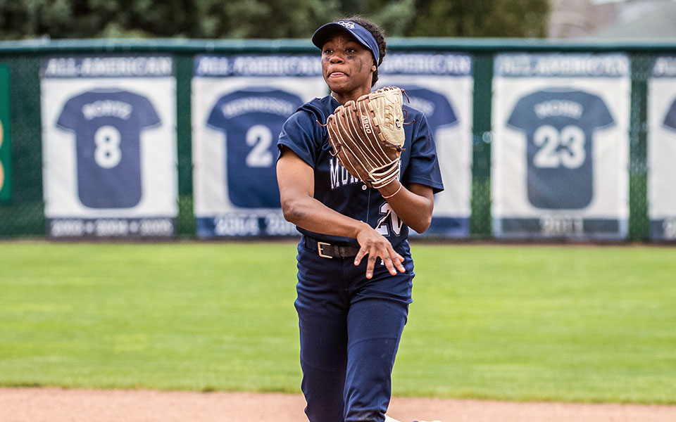 Sophomore Ajala Elmore makes a throw to first base in the second game versus Susquehanna University at Blue & Grey Field. Photo by Cosmic Fox Media / Matthew Levine '11