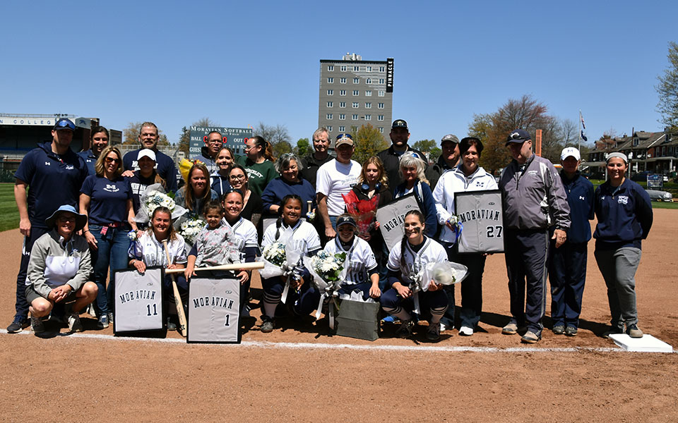 Moravian's 2022 softball seniors and their families on Blue & Grey Field for Senior Day prior to a doubleheader with Elizabethtown College. Photo by Marissa Werner '23