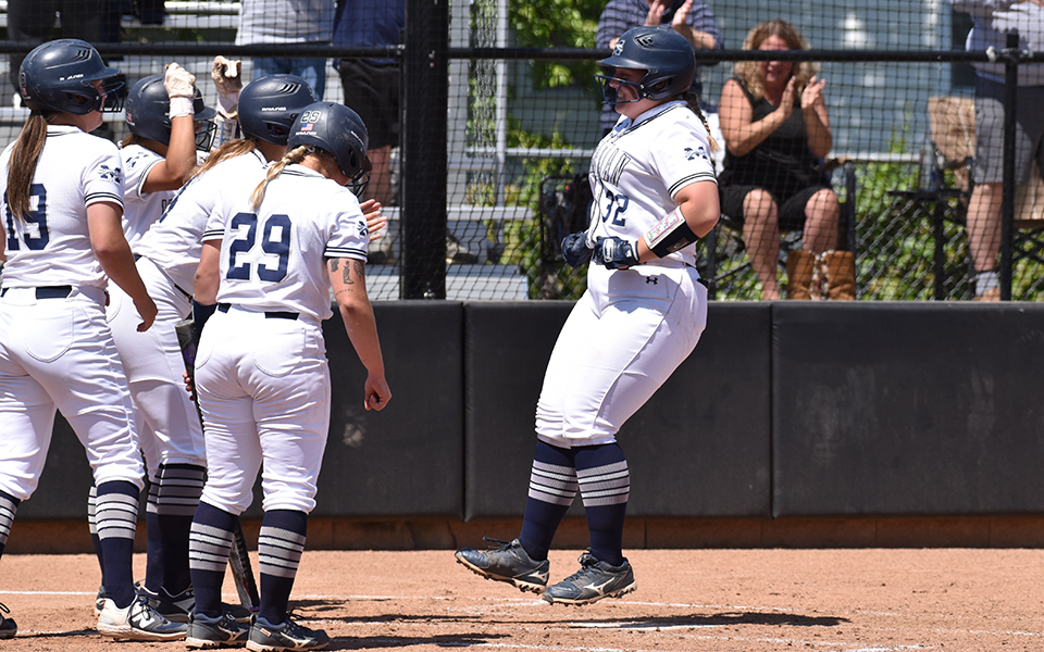 Freshman catcher Marcie Silberman comes to the plate after hitting a grand slam versus Cabrini University in the NCAA Division III Medford (Mass.) Regional. Photo by Ryan Fleming