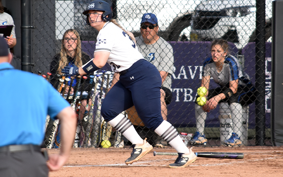 Sophomore catcher Marcie Silberman watches her second home run of the game sail out of Blue & Grey Field versus Elizabethtown College. Photo by Christine Fox