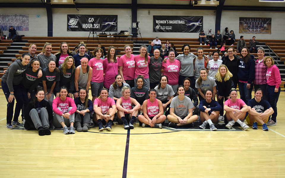 Members of the current women's basketball and former players after the annual alumni game in Johnston Hall.