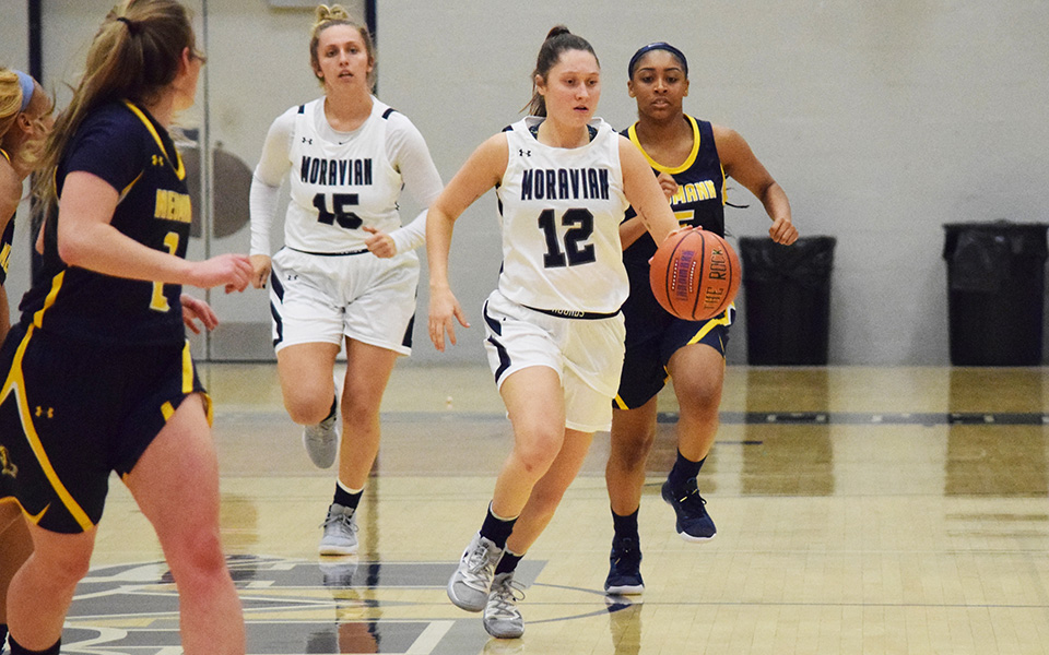 Junior guard Sarah Donati dribbles up the floor during the second half versus Neumann University in the 17th Steel Club Classic in Johnston Hall.
