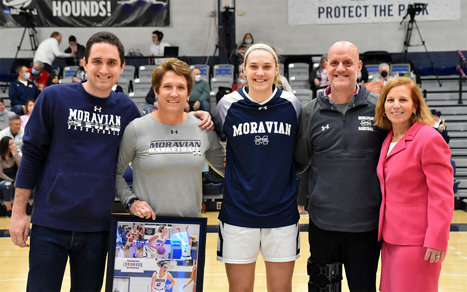 Senior Kayla Yoegel with her family and Head Coach Mary Beth Spirk during the Greyhounds' Senior Day festivities. Photo by Mairi West '23