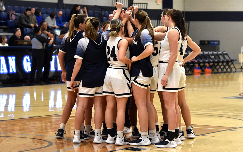 The Greyhounds huddle before tip-off of a game with Elizabethtown College in Johnston Hall earlier this season. Photo by Mairi West '23