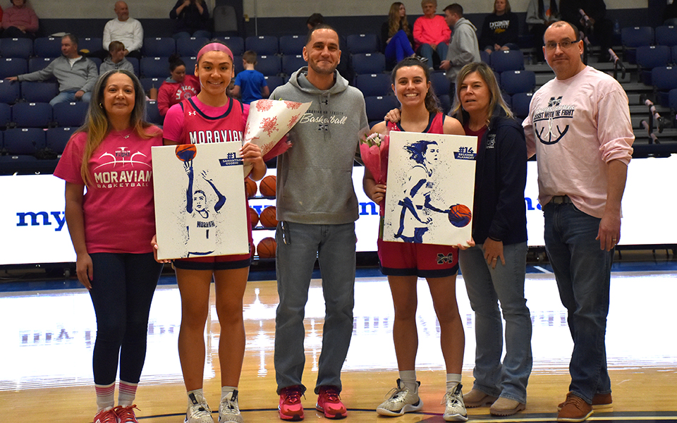 Seniors Sam Osorio and Reganne Flannery and their parents on Senior Day in Johnston Hall. Photo by Grace Nelson '26