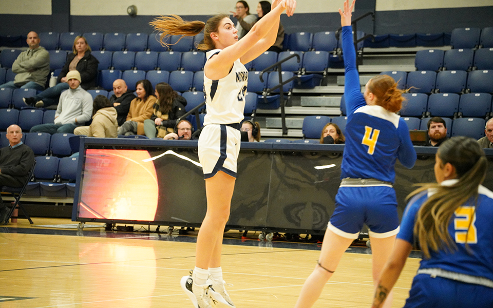 Freshman guard/forward Lizzie Lustig shoots a three-pointer in the first half of a game versus Goucher College in Johnston Hall this season. Photo by Avery Saladino '24