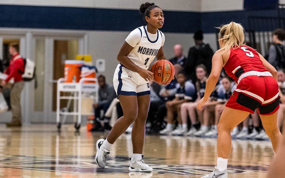 Junior guard Jayda Cartagena dribbles up the court during the first half versus The Catholic University of America in Johnston Hall during the 2023-24 season. Photo by Cosmic Fox Media / Matthew Levine '11