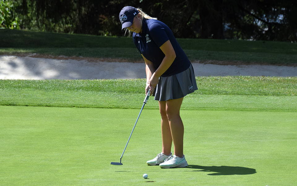Freshman Heidi Wegscheider sinks a putt during the Greyhounds' first-ever tournament at the Hershey Country Club as the squad competed in the Elizabethtown College Fall Blue Jay Invitational. Photo by Christine Fox
