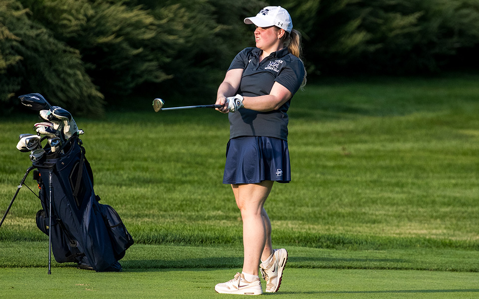 Sophomore Ella Oswald hits a shot off the fairway during the Moravian Weyhill Classic at the Saucon Valley Country Club Weyhill Course earlier this season. Photo by Cosmic Fox Media / Matthew Levine '11