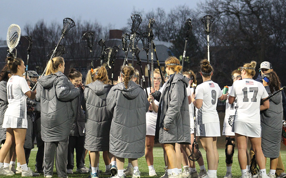 The Greyhounds huddle during a timeout in a match versus Arcadia University on John Makuvek Field.