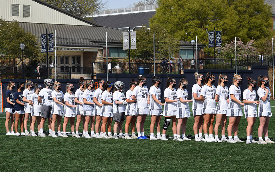 The Greyhounds get ready for the national anthem on John Makuvek Field before their 2021 regular season finale against Juniata College on April 20.